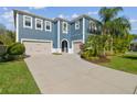 Two-story home with attached garage and manicured landscaping at 4383 Ortona Ln, Wesley Chapel, FL 33543