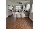 Bright living room with herringbone floors, comfy seating, and large windows at 1006 N Bask Dr, Tampa, FL 33603