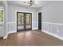 Bright dining room with hardwood floors and French doors at 4290 Yucatan Cir, Port Charlotte, FL 33948