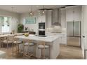 Bright kitchen featuring an island, stainless steel appliances, and white cabinetry at 3801 71St N St, St Petersburg, FL 33709