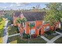 View of well-maintained townhomes, mature trees, and landscaping creating a welcoming community at 9320 Lake Chase Island Way, Tampa, FL 33626