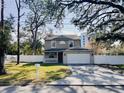 Two-story house with a white garage door and mailbox at 1102 W Charter St, Tampa, FL 33602