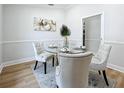 Elegant dining room featuring a glass-top table and four upholstered chairs at 1557 Jeffords St, Clearwater, FL 33756