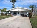 Delightful single-story home featuring a manicured lawn and covered porch at 4415 96Th N Ave, Pinellas Park, FL 33782