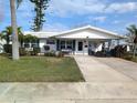 Inviting single-story home with a well-kept lawn and a charming covered porch area at 4415 96Th N Ave, Pinellas Park, FL 33782