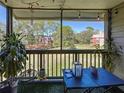 Cozy screened balcony with seating, table and view of the manicured green space at 9100 Dr Martin Luther King Jr N St # 516, St Petersburg, FL 33702