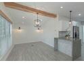 Bright dining room with hardwood floors and modern lighting at 1428 Illinois Ave, Palm Harbor, FL 34683