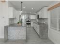 Modern kitchen with concrete countertops and white shaker cabinets at 1428 Illinois Ave, Palm Harbor, FL 34683