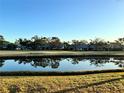 Scenic pond reflecting the trees and homes of the community at 4452 Weybridge St # 74, Sarasota, FL 34235