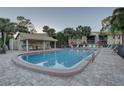 Community pool with shaded seating and plenty of lounge chairs at 4452 Weybridge St # 74, Sarasota, FL 34235