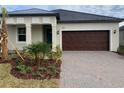 One story home with a two car garage and landscaped yard at 10876 Ibis Brook Ct, Land O Lakes, FL 34638