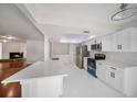 Modern kitchen featuring white cabinets, quartz countertops, and stainless steel appliances at 2308 Long Green Ct, Valrico, FL 33596