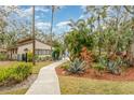 View of the community pool area showcasing lush landscaping and a sidewalk surrounded by greenery at 5110 28Th W St, Bradenton, FL 34207