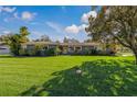 Ranch style home with spacious lawn and mature trees at 1957 Temple Ter, Clearwater, FL 33764