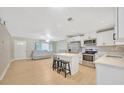 Open concept kitchen and living area with island and stainless steel appliances at 6598 26Th N St, St Petersburg, FL 33702