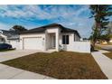 Newly constructed home with modern facade, driveway, and landscaped lawn at 2513 W Hiawatha St, Tampa, FL 33614