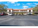 Assigned covered parking area with neatly lined spaces, offering convenient access to the building at 1753 Belleair Forest Dr # E2, Belleair, FL 33756