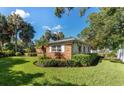 Ranch-style brick home surrounded by lush landscaping at 215 S West Shore Blvd, Tampa, FL 33609