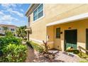 Townhome entry with green door and pathway at 4284 Expedition Way, Osprey, FL 34229