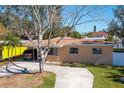 Charming single-story home featuring a covered parking area and a well-manicured lawn at 4145 Harrisburg Ne St, St Petersburg, FL 33703