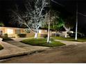 Charming single-story home exterior showcasing a well-lit yard at 4145 Harrisburg Ne St, St Petersburg, FL 33703