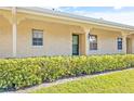 Front view of a condo unit with a neatly trimmed hedge at 2465 Northside Dr # 205, Clearwater, FL 33761