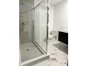 Modern bathroom featuring a glass-enclosed shower, toilet, and dark wood vanity with sink at 3637 63Rd N St, St Petersburg, FL 33710