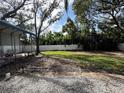 Large backyard with grassy area and partial fence at 4026 Arkansas Ne Ave, St Petersburg, FL 33703