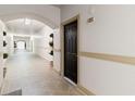 Building hallway with arched entryways and potted plants at 501 Knights Run Ave # 1217, Tampa, FL 33602