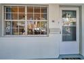 Close-up highlighting the condo's entryway with a view through the window to the landscape at 11200 102Nd N Ave # 66, Seminole, FL 33778