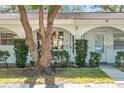 Close-up highlighting the condo's archway details, manicured landscaping, and inviting front entrance at 11200 102Nd N Ave # 66, Seminole, FL 33778