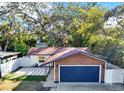 Charming exterior view of the house featuring a well-kept yard, patio, and surrounding trees at 1220 Dr Ml King Jr St N, Safety Harbor, FL 34695