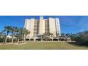 Luxury high-rise building with manicured lawn at 10851 Mangrove Cay Ne Ln # 1112, St Petersburg, FL 33716