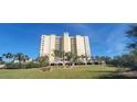 Multi-story building with palm trees and landscaped grounds at 10851 Mangrove Cay Ne Ln # 1112, St Petersburg, FL 33716