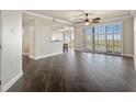 Spacious living room with dark tile floors and sliding doors to balcony at 10851 Mangrove Cay Ne Ln # 1112, St Petersburg, FL 33716