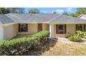 Front entrance of a house with a tiled porch and landscaping at 3722 Village Estates Pl, Tampa, FL 33618