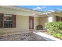 Front porch with a decorative bench and access to the front door at 3722 Village Estates Pl, Tampa, FL 33618