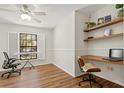 Home office with built-in shelves and hardwood floors at 3722 Village Estates Pl, Tampa, FL 33618