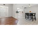 Kitchen and dining area with tile flooring and white cabinets at 3722 Village Estates Pl, Tampa, FL 33618