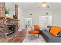 Living room features a brick fireplace and comfortable seating at 3722 Village Estates Pl, Tampa, FL 33618