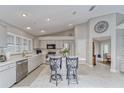 Bright kitchen with island, stainless steel appliances, and white quartz countertops at 9719 Pleasant Run Way, Tampa, FL 33647