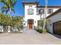 Front view of home with wood door and brick pavers at 158 Ramon Ne Way, St Petersburg, FL 33704