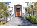 Elegant entryway with wood door and wrought iron railings at 158 Ramon Ne Way, St Petersburg, FL 33704