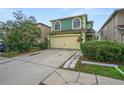 Two-story house with green exterior, attached garage, and landscaping at 1613 Prowmore Dr, Brandon, FL 33511