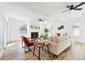 Bright living room with fireplace, hardwood floors, and access to backyard at 523 Deville E Dr, Largo, FL 33771