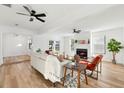 Open living room featuring a fireplace, hardwood floors, and adjacent dining area at 523 Deville E Dr, Largo, FL 33771