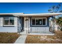 Quaint front porch with wrought-iron railings and white door at 4051 30Th N Ave, St Petersburg, FL 33713