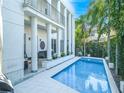 Inviting pool area with a modern design, surrounded by lush tropical landscaping at 2711 W Trilby Ave, Tampa, FL 33611