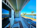 Relaxing balcony with rocking chairs and waterfront view at 611 Destiny Dr # 207, Ruskin, FL 33570