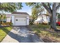 Front view of charming condo with attached garage and well-maintained landscaping at 155 Nina Way, Oldsmar, FL 34677